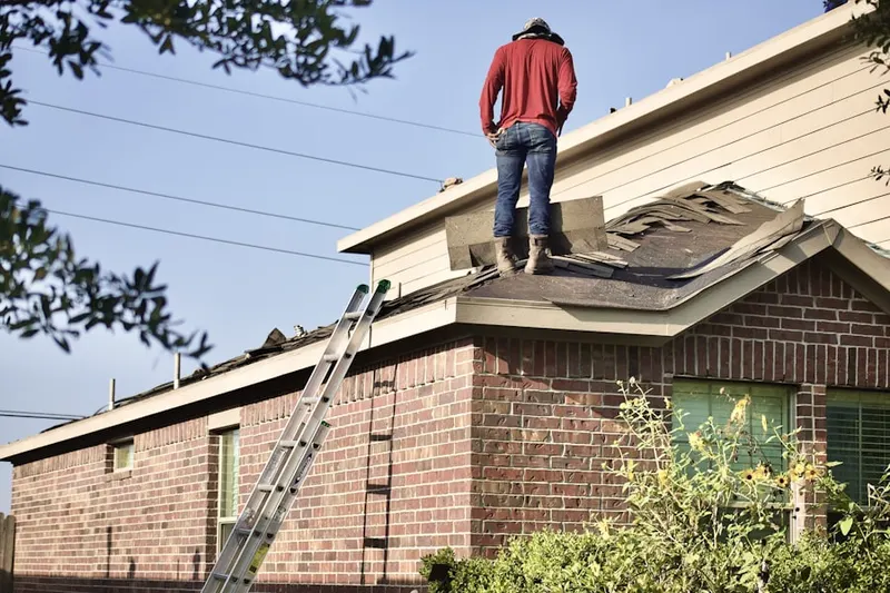 Professional roofer working on a residential roof in Hanford